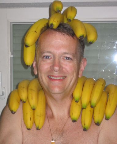 Tom with bananas on his head and shoulders